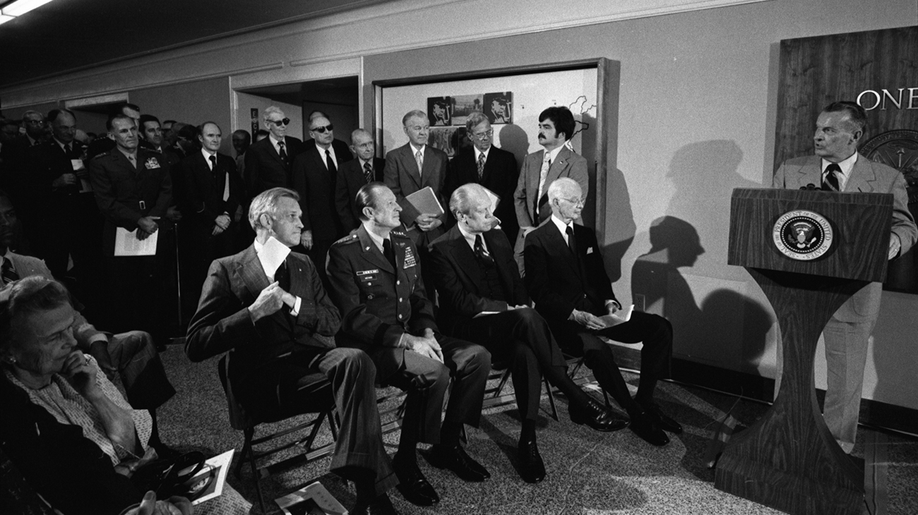Clements speaking at podium to dedicate the George C Marshall corridor in the Pentagon, April 20, 1976.
