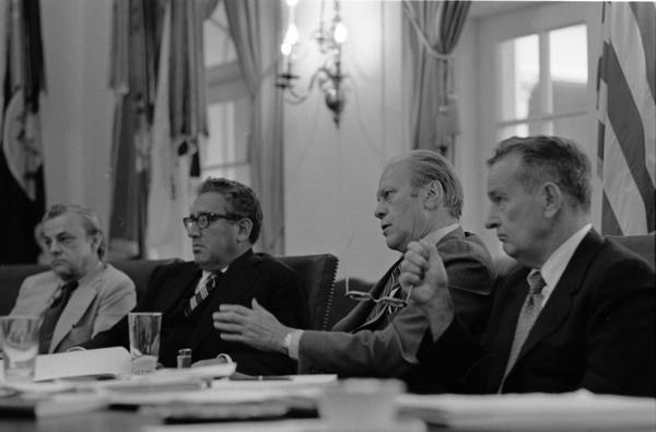 Ambassador L. Dean Brown, Secretary of State Henry Kissinger, President Gerald Ford, and Deputy Secretary of Defense William Clements attend a meeting of the National Security Council in the White House Cabinet Room, 6/17/976.