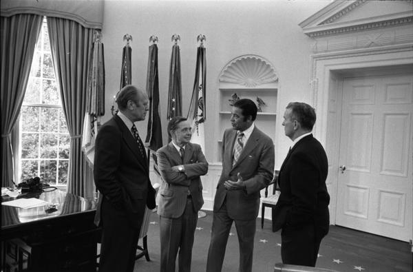 President Gerald Ford, Assistant Secretary of Defense William Clements, Representative Carl Albert, and Senator Edward Brooke discuss the Combined Federal Campaign in the Oval Office, 9/17/1974.