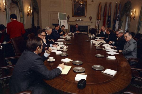 President Gerald Ford, James Schlesinger, General George Brown, Fred Iklé, William Colby, Robert Ingersoll, U. Alexis Johnson, William Clements, Jan Lodal, Brent Scowcroft, and Donald Rumsfeld attend a National Security Meeting in the White House Cabinet Room, 12/2/1974.