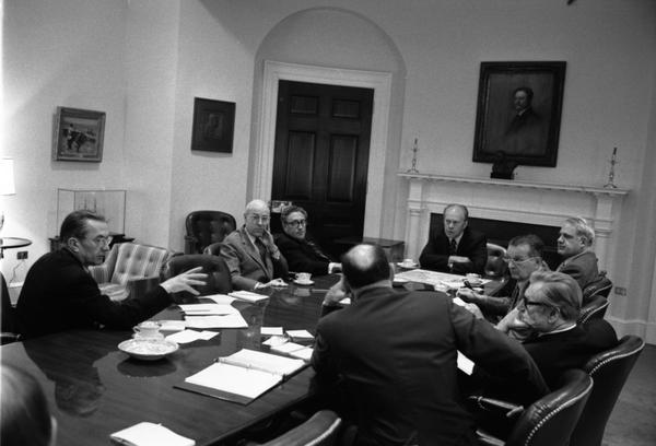Gerald Ford, Nelson Rockefeller, Henry Kissinger, James Schlesinger, General George S. Brown, William Colby, Robert Ingersoll, William Clements, Brent Scowcroft, and W. R. Smyser attend a National Security Meeting in the White House Roosevelt Room, 4/28/1975.