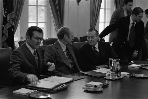 Gerald Ford, Donald Rumsfeld, William Clements, General John Wickham, Terence McClary, Leonard Sullivan, Richard Cheney, Brent Scowcroft, James Lynn, Paul O'Neill, Donald Ogilvie, Dale McOmber, and General George S. Brown attend a meeting with the Joint Chiefs of Staff and the Secretary of Defense to discuss the 1977 United States budget, 12/13/1975.